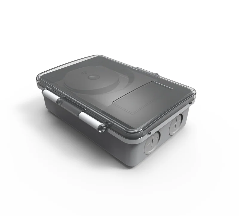 LC421 load control shown from the front, grey case with a transparent lid over a round dial bearing a wireless icon
