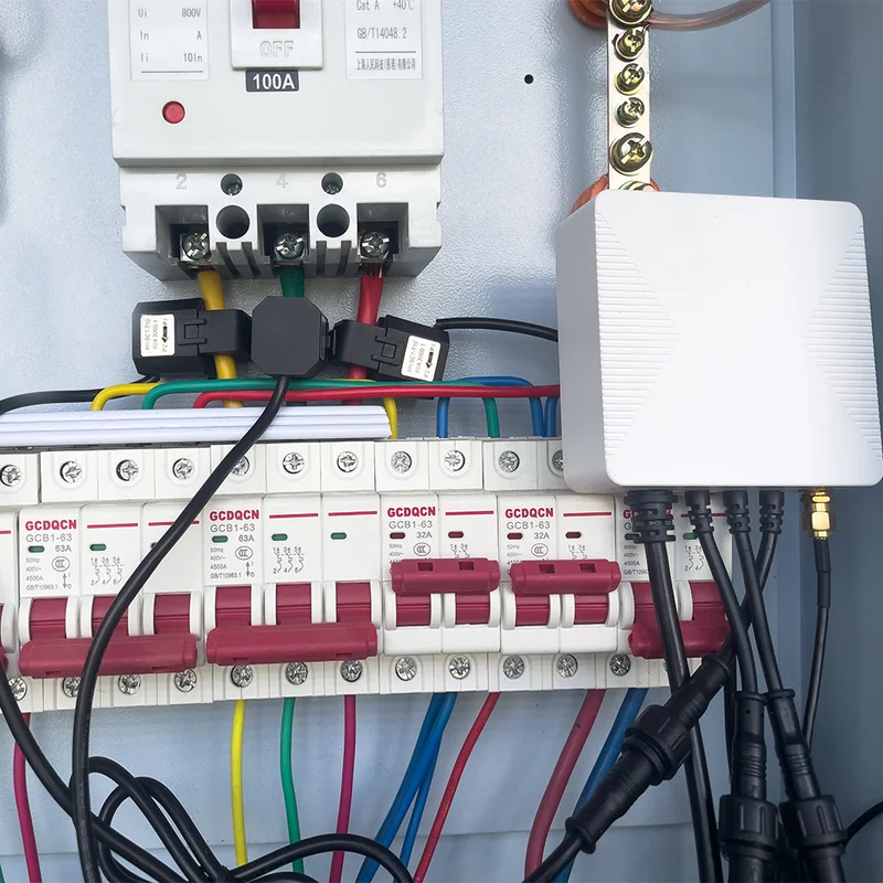 PC321-W-TY meter installed in a consumer unit with a 100A main switch and CT clamps clipped onto live cables