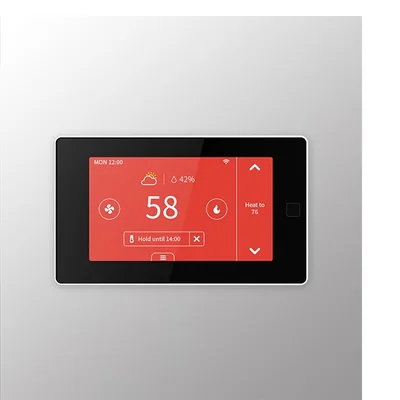 PCT513-TY touchscreen thermostat fitted on a grey wall, its red screen showing 58 and Heat to 76