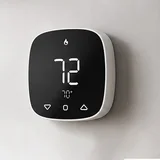 PCT523-W-TY square thermostat on a wall showing 72 with a flame icon above a 70 degree setpoint