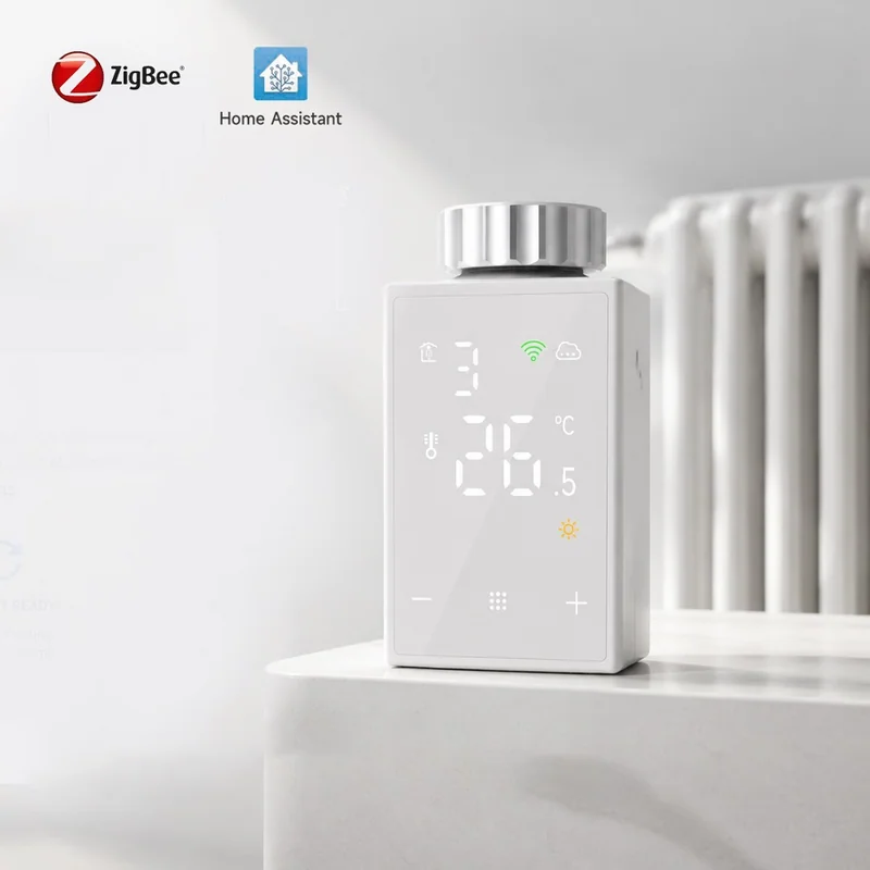 TRV527-Z ZigBee radiator valve fitted to a white radiator, LCD showing 26.5 C, with ZigBee and Home Assistant badges